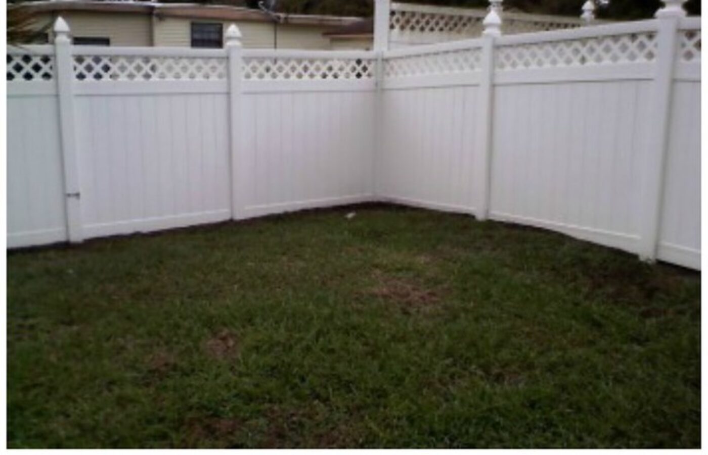 The same vinyl fence bright white after cleaning