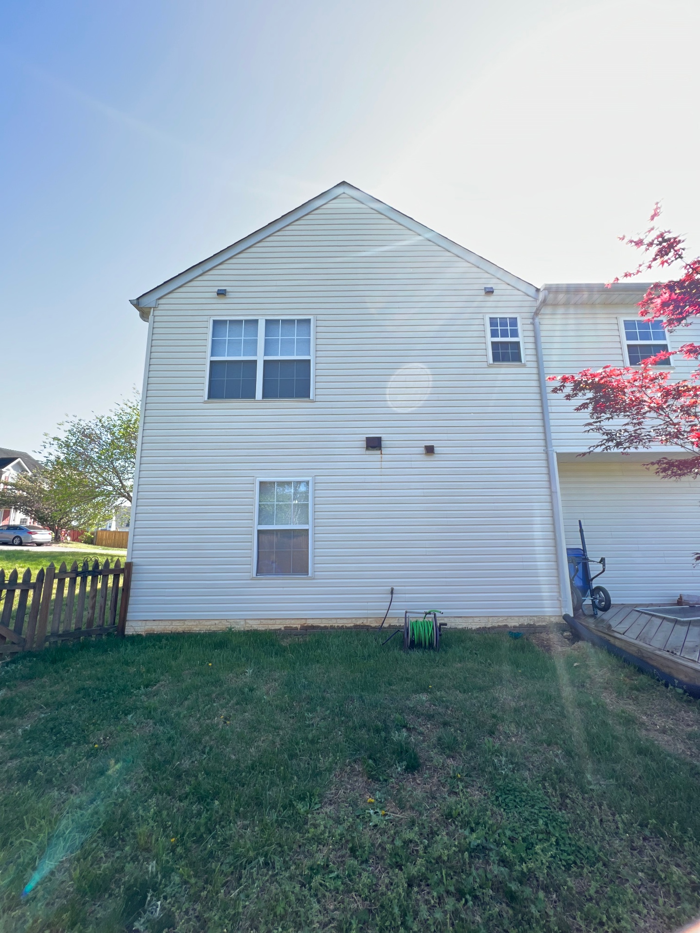 The same cream vinyl siding restored and clean after soft washing