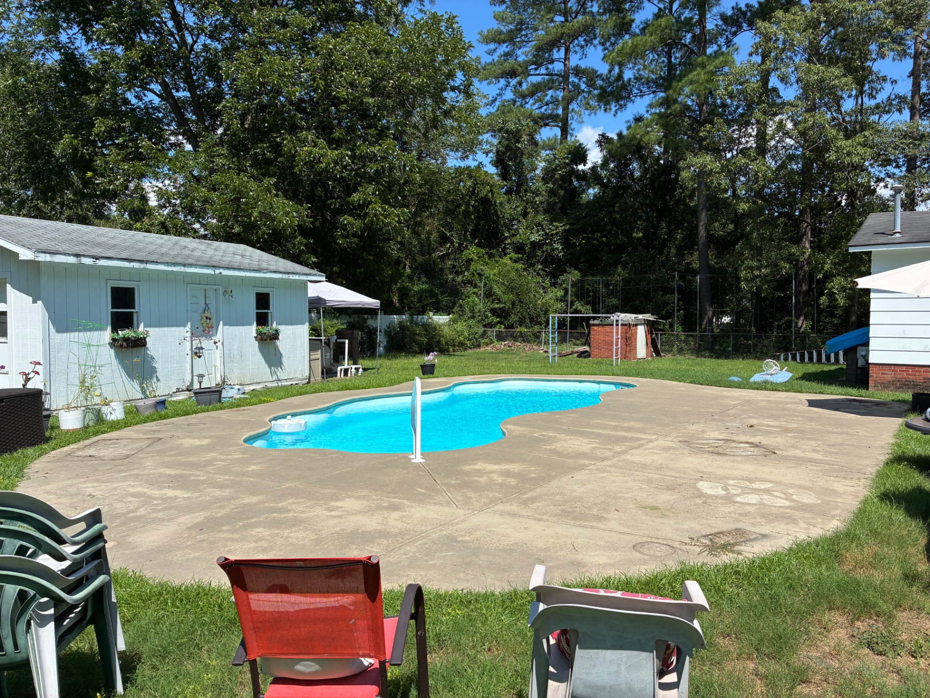 Concrete pool deck before pressure washing, with dirt, stains, and organic buildup